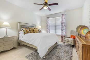 a bedroom with a bed and a ceiling fan